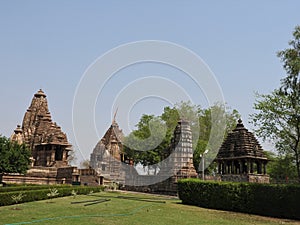 Beautiful image of Kandariya Mahadeva temple, Khajuraho, Madhyapradesh, India with blue sky and fluffy clouds in the background,