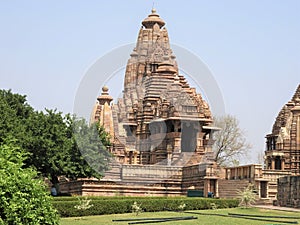 Beautiful image of Kandariya Mahadeva temple, Khajuraho, Madhyapradesh, India with blue sky and fluffy clouds in the background,