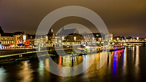 Beautiful image of the river Maas with a boat with beautiful reflections of multicolored light