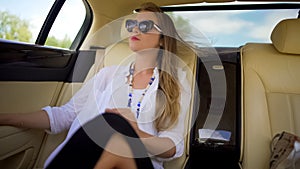 Beautiful independent woman enjoying car trip on vacation, business traveler