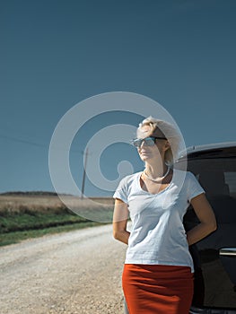 Beautiful independent woman enjoying road trip. Successful woman