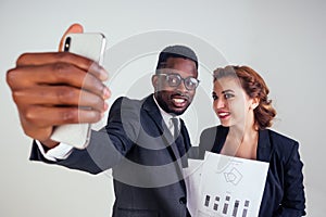 Beautiful indian female business leader with multiracial business partner African American man taking selfie on a