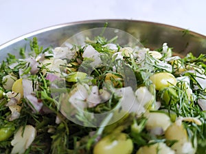 Beautiful Indian food mixture of sabbakki, onion & avarekalu to do the dosa in a steel plate background