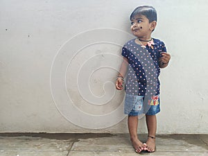 Beautiful Indian Girl Kid Standing and Doing Different Activities like, smiling, dancing, hand movement etc