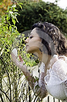 Beautiful Indian girl smelling a white rose