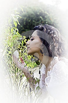 Beautiful Indian girl smelling a white rose