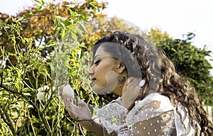 Beautiful Indian girl smelling a white rose