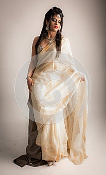 Beautiful Indian lady female model in cream white dress