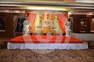 Beautiful Indian wedding ceremony stage set in colors and entrance in red and floral designs