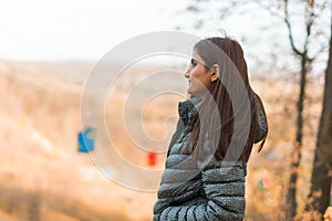 Beautiful indian woman generation z relaxing and feeling nature at autumn park in fall season copy space. Diversity and