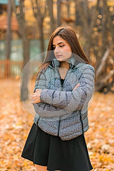 Beautiful indian woman generation z relaxing and feeling nature at autumn park in fall season copy space. Diversity and