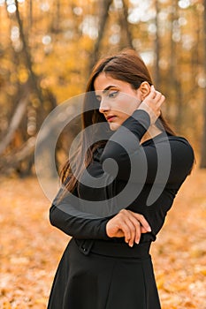 Beautiful indian woman generation z relaxing and feeling nature at autumn park in fall season. Diversity and gen z youth