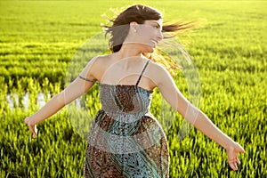 Beautiful indian woman in green rice fields