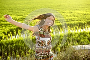 Beautiful indian woman in green rice fields