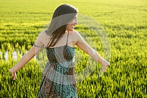 Beautiful indian woman in green rice fields