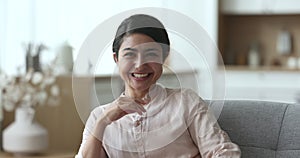 Beautiful Indian woman posing for head shot portrait at home