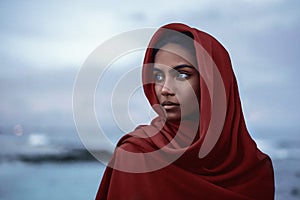 Beautiful indian woman with red paranja and blue eyes in the twilight photo