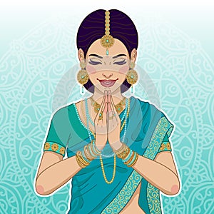 Beautiful indian woman saying namaste photo