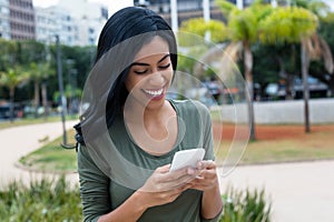 Beautiful indian woman sending message with phone