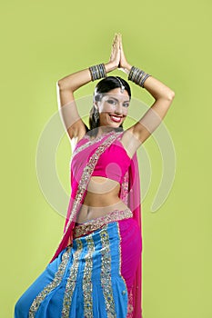 Beautiful indian young brunette woman dancing