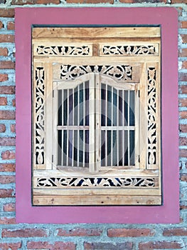 Beautiful indonesian wooden window on bricks wall