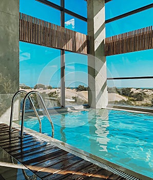 Beautiful indoor swimming pool in luxury spa hotel or holiday villa at seaside