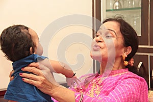 Beautiful Infant playing with grand mother