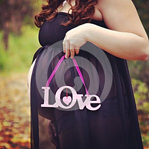 Beautiful instagram of pregnant woman holding quote forest path