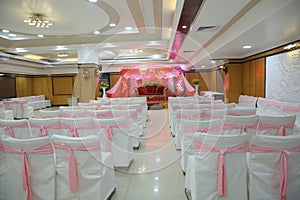 Beautiful interior design and Wedding stage, flowers for decoration and pink dominates in colours of decoration.