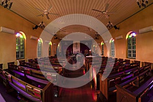 Beautiful interior view of little country church with empty wooden pews