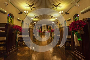 Beautiful interior view of little country church with empty wooden pews