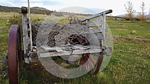 Beautiful invoicing wooden cart in the village. Rural atmosphere. Old wooden cart in a picturesque location