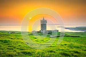 Beautiful irish castle near Atlantic ocean at sunset