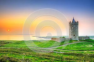 Beautiful irish castle near Atlantic ocean at sunset