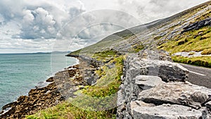 Beautiful Irish landscape with the sea and the rural coastal road alongâ€‹â€‹ the Burren