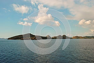 Beautiful island beach. View of tropical beach with blue sky In Labuan Bajo, Indonesia. Perfect blue sky with clouds and water of