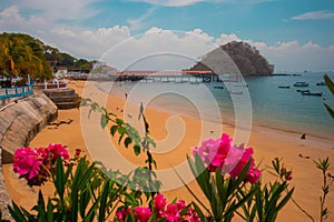 Beautiful island of Taboga, close to Panama city. View of the coastal town and a local landmark a statue of a fish. Looking