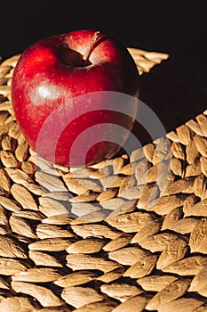 Beautiful isolated red apple illuminated on tablemats