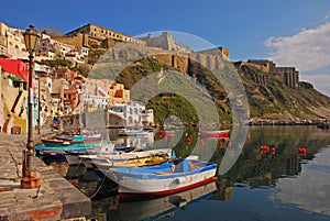 Beautiful Italian seaside view of Procida, Napoli with many small colorful wooden boats docked