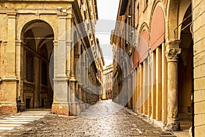 Beautiful Italian street, colourful buildings with porticos. Bologna, Italy