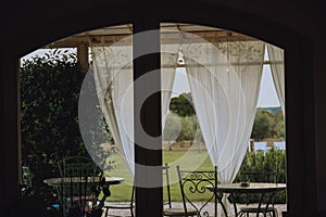 Beautiful Italian-style terrace in a field with olive fields in the background. Comfort and relaxation, boho style