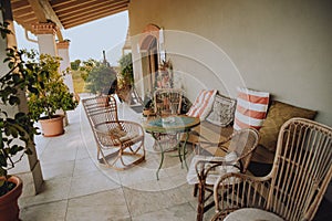 Beautiful Italian-style terrace in a field with olive fields in the background. Comfort and relaxation, boho style