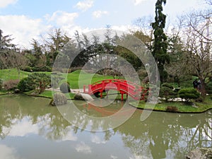 Beautiful Japanese garden in the city of Toulouse with lake and bridge photo