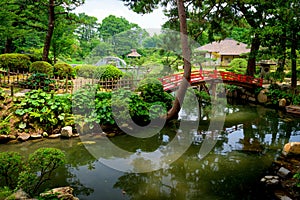 Beautiful Japanese Garden in Hiroshima with red bridge