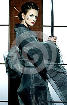 Beautiful japanese kimono woman with samurai sword