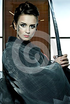 Beautiful japanese kimono woman with samurai sword