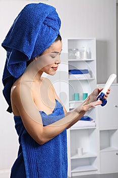 Beautiful japanese woman using moisturiser photo