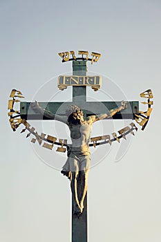 Beautiful Jesus Christ crucifixion bronze statue during sunrise, Statuary of the St. Cross with Calvary, Charles Bridge, Prague