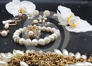 Beautiful jewelry white pearl  set  for woman and girl necklace earrings  bracelet   earring rings on black gold silver  backgroun