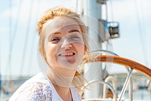 Beautiful and joyful girls, smiling friends, on the deck of a yacht